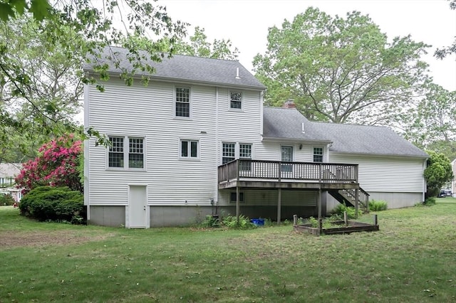 40 Langley Ln, Tewksbury, MA 01876 - back of property with a deck, a lawn, a chimney, and a shingled roof