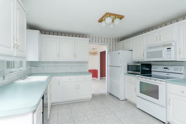 40 Langley Ln, Tewksbury, MA 01876 - kitchen featuring white appliances, a sink, white cabinets, and light countertops