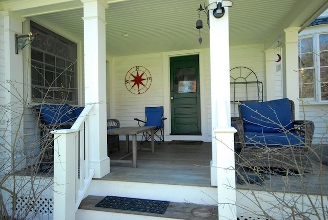 view of exterior entry with covered porch
