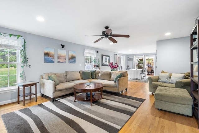 living area featuring baseboards, ceiling fan, wood finished floors, and recessed lighting