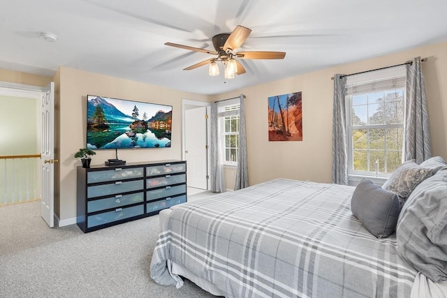 carpeted bedroom featuring ceiling fan and baseboards