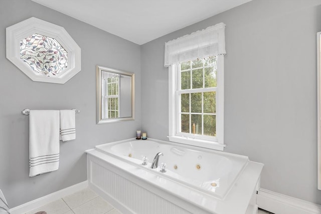 full bathroom with a whirlpool tub, baseboards, tile patterned floors, and a healthy amount of sunlight