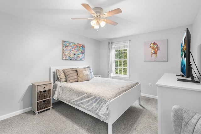 bedroom featuring a ceiling fan, light carpet, and baseboards