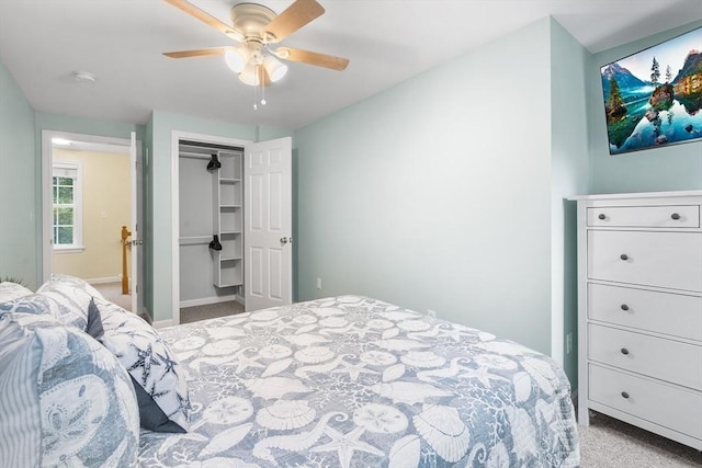 carpeted bedroom featuring a ceiling fan, baseboards, and a closet