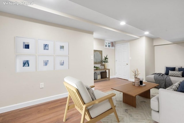 living room featuring light wood-style floors, baseboards, and recessed lighting