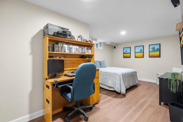 bedroom featuring light wood-style flooring and baseboards