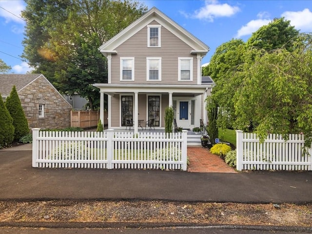 55 Dwight St, Dedham, MA 02026 - view of front of house featuring covered porch and a fenced front yard
