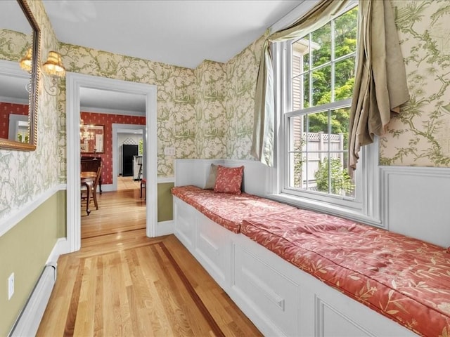 55 Dwight St, Dedham, MA 02026 - hall featuring wallpapered walls, light wood-style floors, a baseboard heating unit, and a wainscoted wall