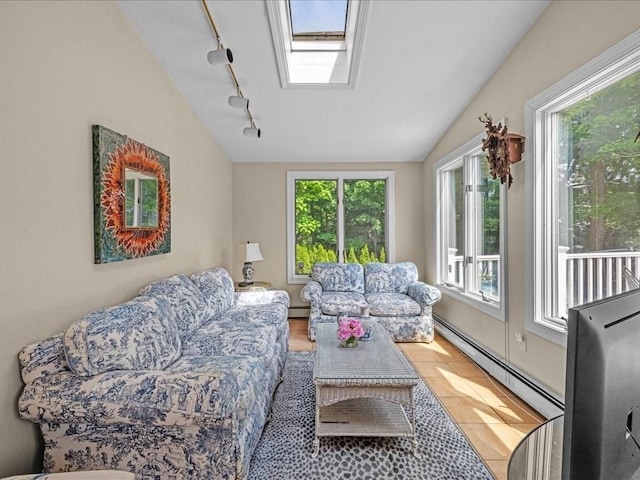 55 Dwight St, Dedham, MA 02026 - living room featuring rail lighting, a baseboard radiator, plenty of natural light, vaulted ceiling, and a skylight