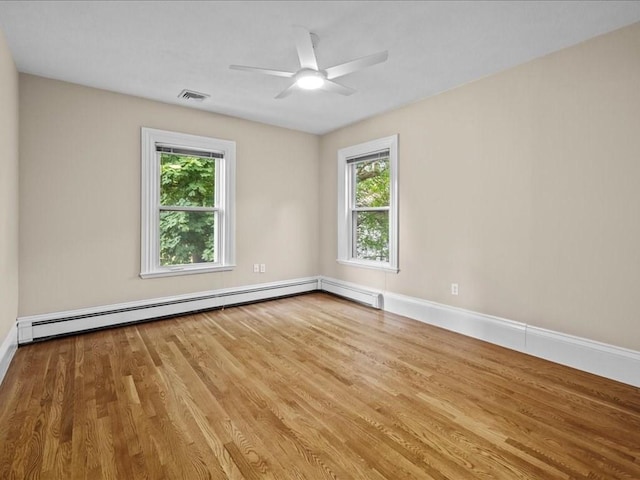 55 Dwight St, Dedham, MA 02026 - empty room featuring wood finished floors, plenty of natural light, and baseboards