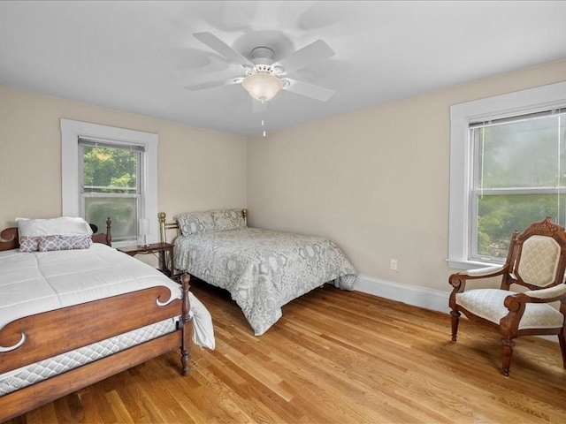 55 Dwight St, Dedham, MA 02026 - bedroom with light wood-type flooring, baseboards, and ceiling fan