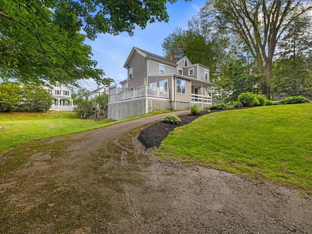 55 Dwight St, Dedham, MA 02026 - view of side of home featuring a lawn, a chimney, asphalt driveway, and covered porch