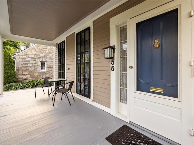 55 Dwight St, Dedham, MA 02026 - property entrance featuring covered porch and stone siding