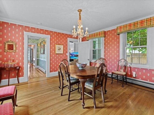 55 Dwight St, Dedham, MA 02026 - dining area featuring crown molding, a chandelier, light wood-style flooring, wallpapered walls, and a baseboard heating unit