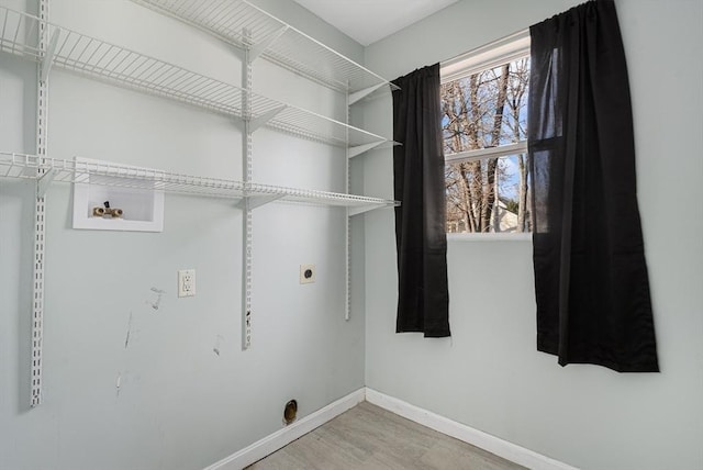 laundry room with washer hookup, electric dryer hookup, and hardwood / wood-style floors