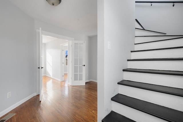 stairs with wood-type flooring