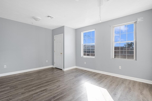 unfurnished room with dark hardwood / wood-style flooring