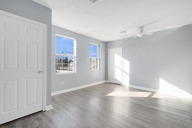 empty room featuring wood-type flooring and ceiling fan