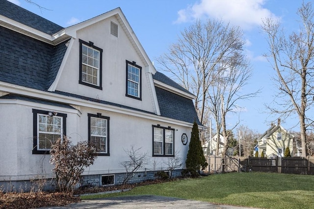 view of side of home featuring a lawn