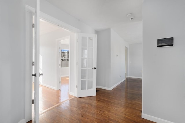 corridor with dark hardwood / wood-style floors