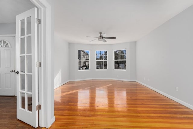 empty room featuring hardwood / wood-style flooring and ceiling fan