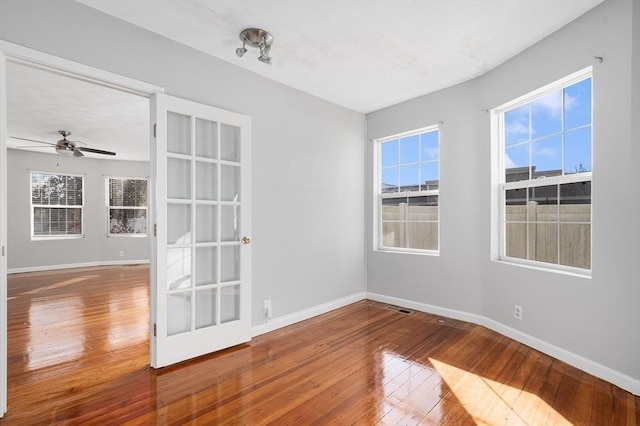 unfurnished room featuring hardwood / wood-style floors and ceiling fan