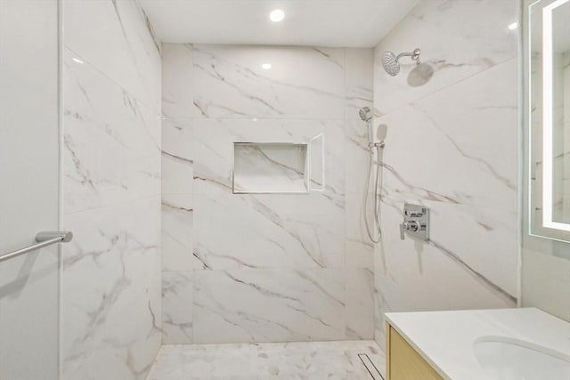 full bath featuring recessed lighting, vanity, and a marble finish shower