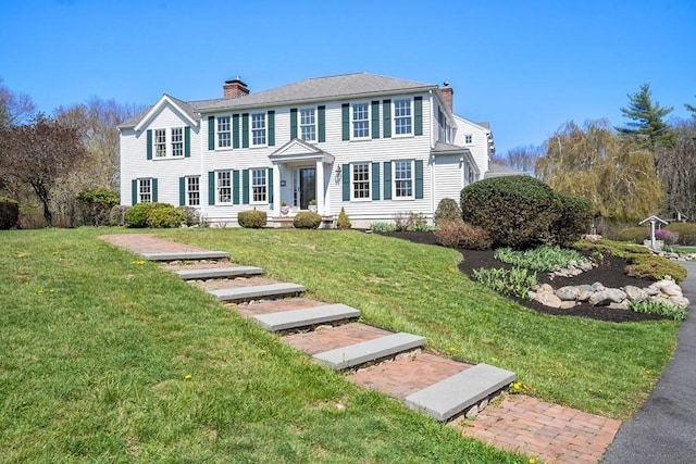 619 Main St, Hanover, MA 02339 - colonial-style house featuring a chimney and a front lawn