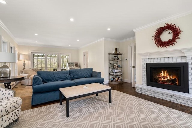 619 Main St, Hanover, MA 02339 - living area with wood finished floors, a fireplace, recessed lighting, crown molding, and baseboards
