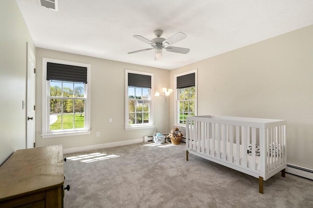 619 Main St, Hanover, MA 02339 - bedroom with carpet, baseboard heating, baseboards, a ceiling fan, and a crib