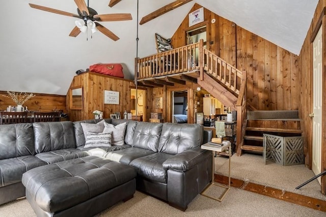 619 Main St, Hanover, MA 02339 - living room featuring wooden walls, carpet, stairway, ceiling fan, and high vaulted ceiling