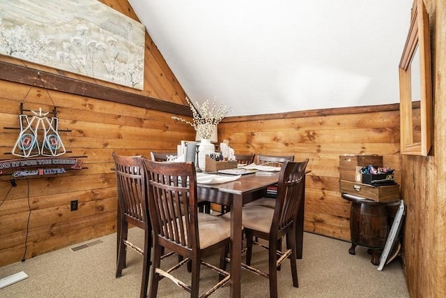 619 Main St, Hanover, MA 02339 - dining space with carpet floors, wood walls, and vaulted ceiling