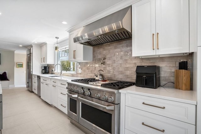 619 Main St, Hanover, MA 02339 - kitchen featuring stainless steel appliances, wall chimney range hood, light countertops, white cabinetry, and recessed lighting