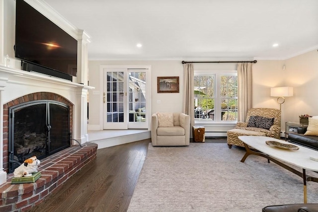 619 Main St, Hanover, MA 02339 - living room featuring ornamental molding, wood finished floors, a brick fireplace, recessed lighting, and baseboard heating