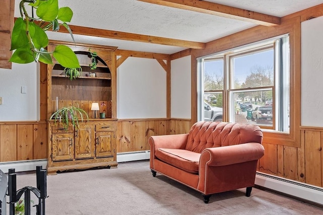 living area with wood walls, wainscoting, and beamed ceiling