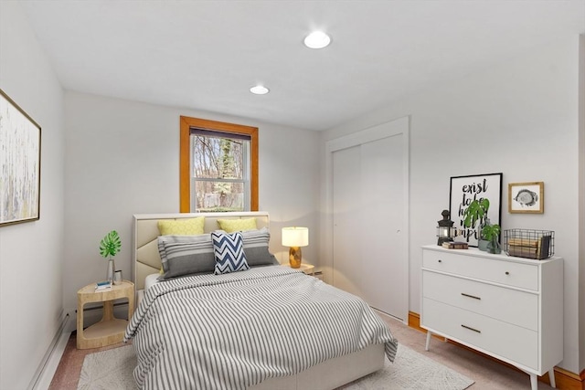carpeted bedroom with a closet, recessed lighting, and baseboards