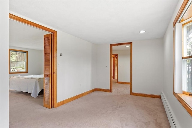 carpeted empty room featuring recessed lighting, baseboards, and baseboard heating