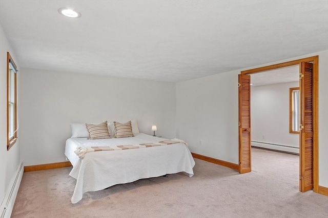 bedroom with baseboards, light carpet, and a baseboard radiator