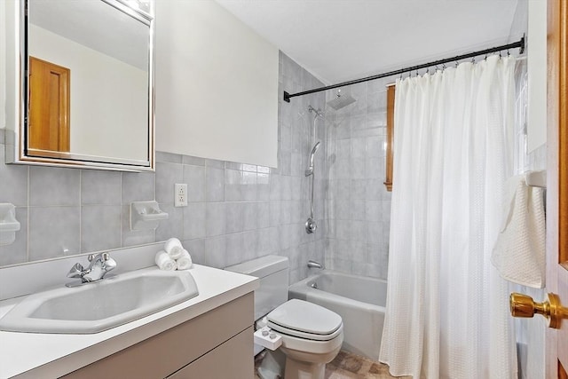 bathroom with toilet, tile walls, shower / tub combo with curtain, and vanity
