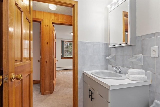 bathroom with vanity, tile walls, and a baseboard radiator