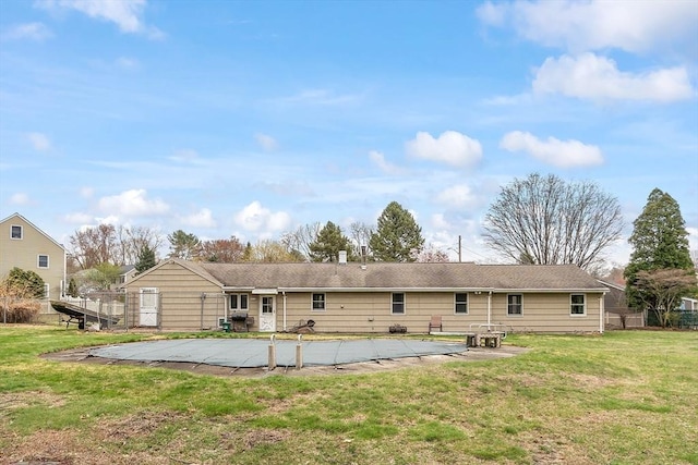 back of house with a patio area and a yard
