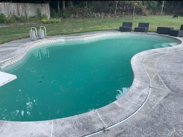 view of pool with a lawn, fence, and a fenced in pool