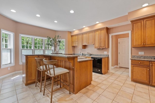 26 Sam Cobb Ln, Princeton, MA 01541 - kitchen featuring black dishwasher, light tile patterned floors, a kitchen island, a breakfast bar, and stone counters