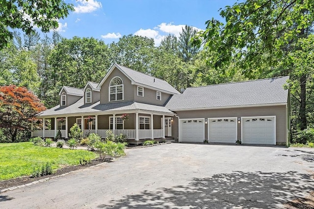 26 Sam Cobb Ln, Princeton, MA 01541 - view of front of house with driveway, a garage, covered porch, a front yard, and view of wooded area