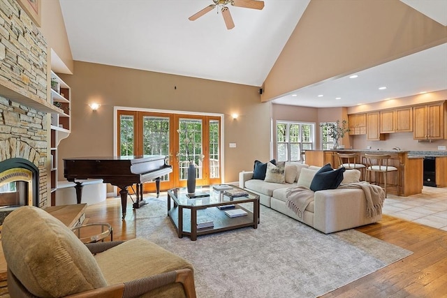 26 Sam Cobb Ln, Princeton, MA 01541 - living room with ceiling fan, light wood finished floors, a fireplace, high vaulted ceiling, and french doors
