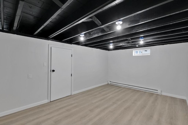 69 Notre Dame St, Springfield, MA 01104 - below grade area with a baseboard radiator, wood finished floors, and baseboards