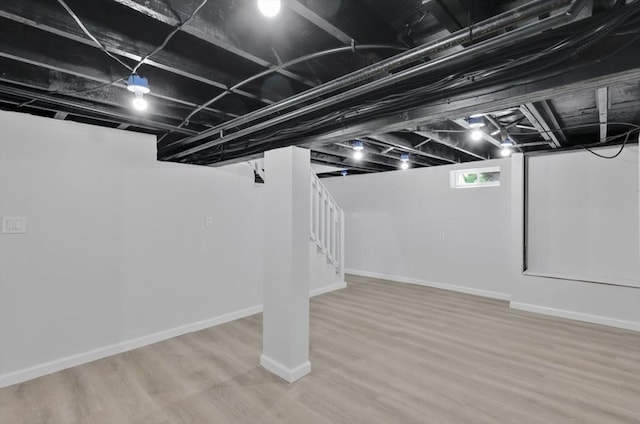 69 Notre Dame St, Springfield, MA 01104 - basement featuring stairs, wood finished floors, and baseboards