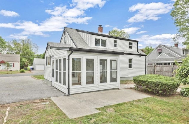 69 Notre Dame St, Springfield, MA 01104 - back of house featuring a chimney, roof with shingles, and a patio area