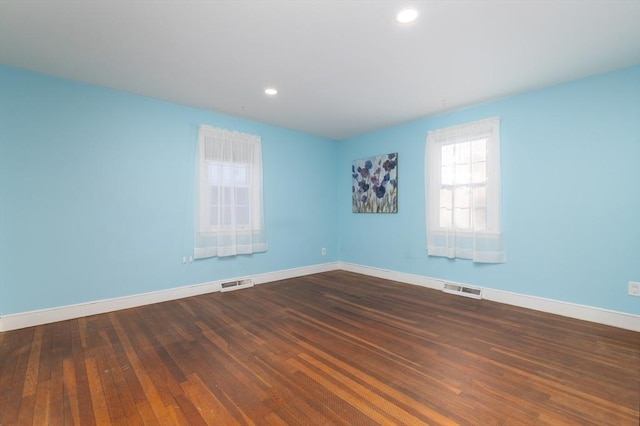 empty room with dark wood-type flooring