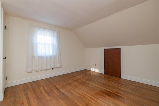 bonus room featuring lofted ceiling and wood-type flooring